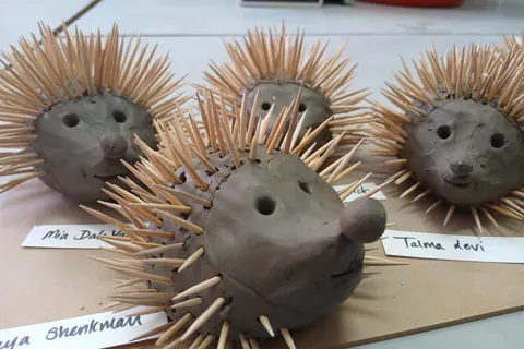 Close view of several clay hedgehog sculptures