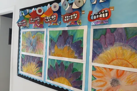 Large flower drawings displayed on a classroom board