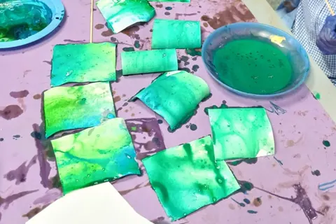 Green painted papers from a creative art session