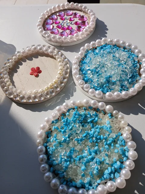 Pearl-edged coasters with pink heart gems and blue glass stones