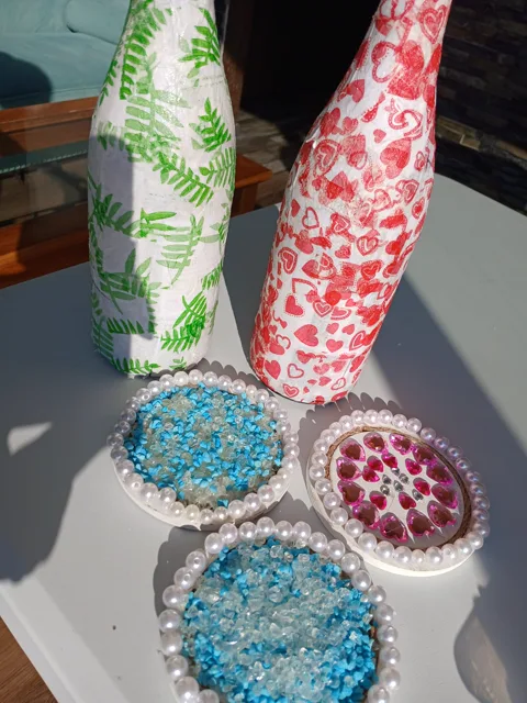Finished floral bottles and blue and pink gemstone coasters in the studio