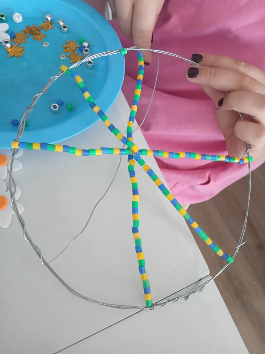 Bright beads forming an eight-point star inside a wire circle