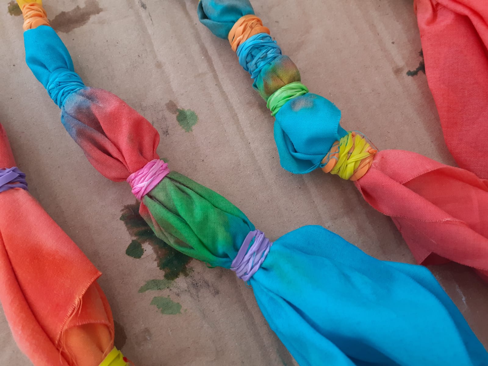 Bright tie-dye fabric pieces tied with colourful bands