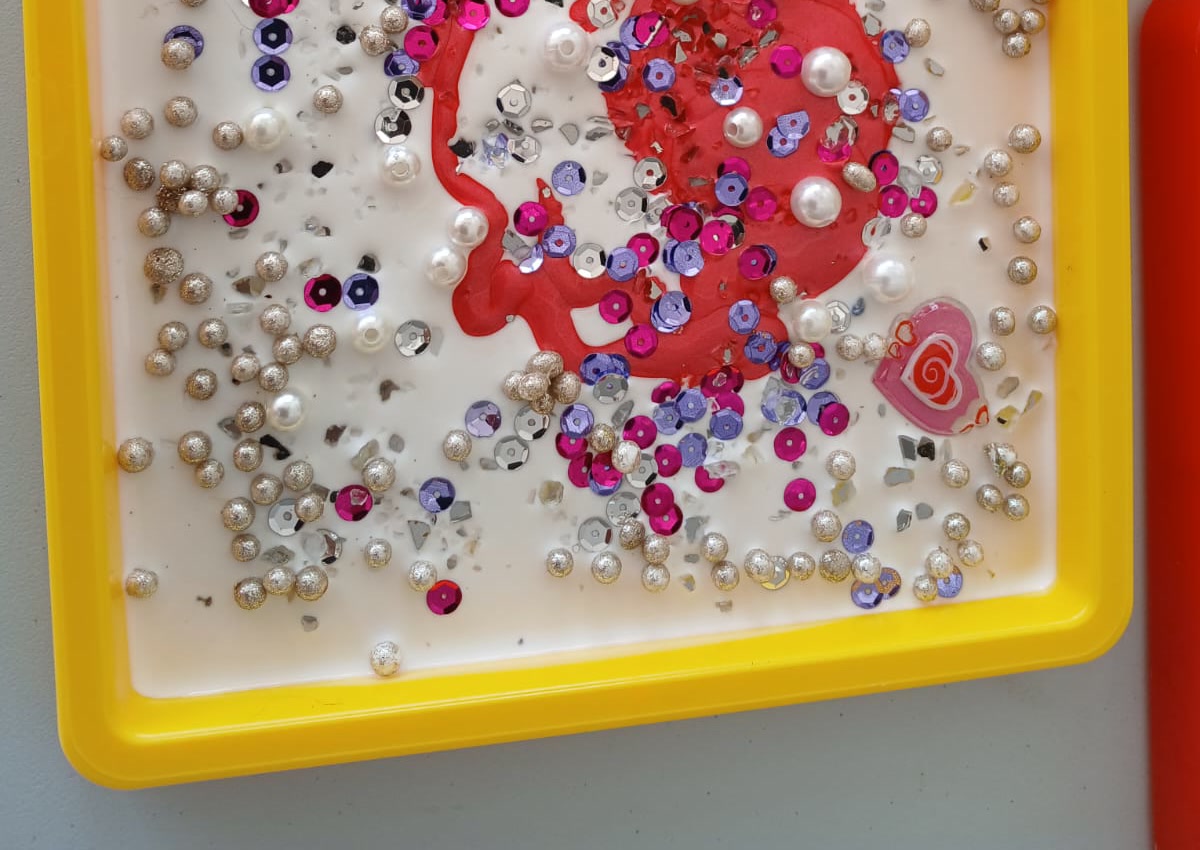 Finished sensory craft trays on an art table