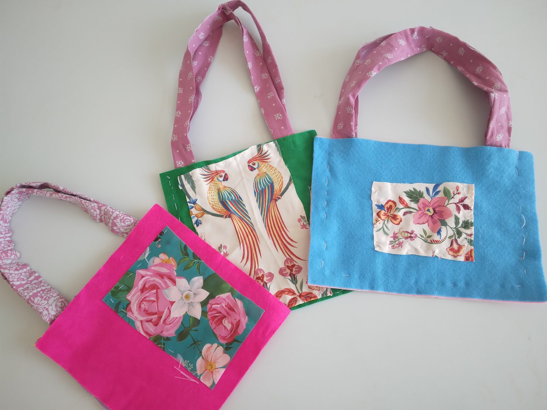 Colourful handmade fabric bags with floral and parrot designs